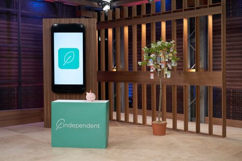 Bühnenbild von Höhle der Löwen mit dem Geldbaum und dem übergrossen Mobile Screen mit der Anlage-App von findependent