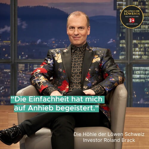 Investor Roland Brack sitzt in einem Stuhl, trägt ein auffälliges Sakko und sagt 